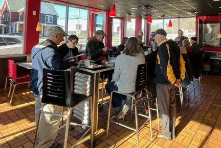 Group of people eating at a restaurant.