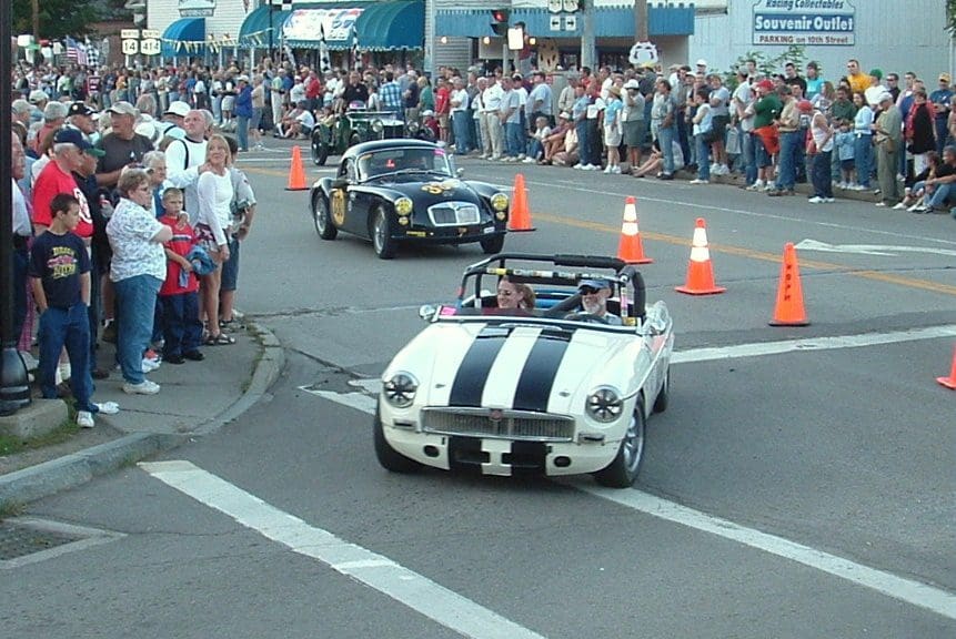 Black and white convertible with spectators.