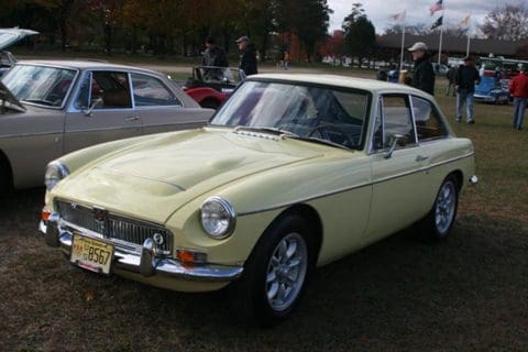 2023 NJ Britfest Yellow MG MGB roadster parked on grass.