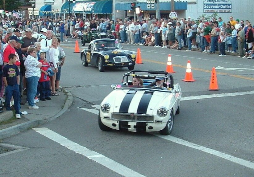 Black and white convertible with spectators.